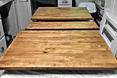 three wooden boards sitting on top of a kitchen counter