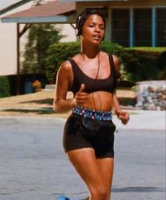 a woman running down the street on a skateboard