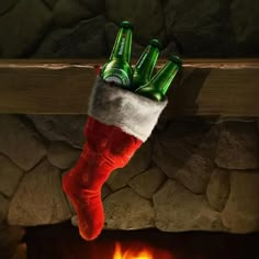 a christmas stocking hanging over a fireplace with beer bottles in it's stockings