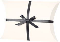 a white pillow with a black ribbon on it