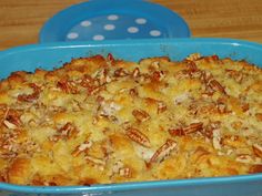 a blue casserole dish filled with bread and pecans