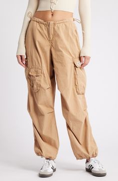 These Y2K-inspired cargo pants feature a baggy low-rise silhouette, plenty of pockets and a toggle-adjustable waist. 29 1/2" inseam; 12" leg opening; 10" front rise; 14 1/2" back rise (size medium) Exclusive retailer Zip fly with hook-and-bar closure Drawcord-toggle waist Front slant pockets; back patch pocket; cargo flap-patch and flap-bellows pockets 100% cotton Machine wash, line dry Made in Turkey Mnml Bungee Cord Pants, Tan Cargo Pants Women, Cheap Urban Outfitters Summer Pants, Yellow Hiking Pants, Low Rise Tan Cargo Pants, Khalana Barfield For Target, Zara Cargo Joggers, Women’s Cargo Pants, Cuffed Cargo Pants