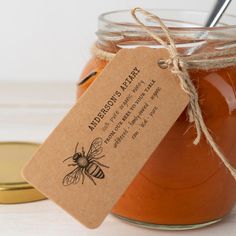 a jar filled with honey sitting on top of a table