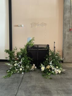 an arrangement of flowers and greenery on the floor