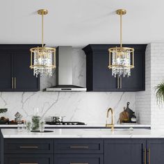 a kitchen with marble counter tops and dark blue cabinetry, gold trimmings