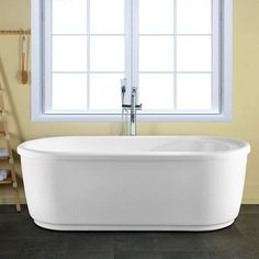 a white bath tub sitting next to a window