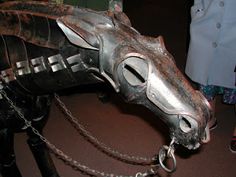 a metal horse head with chains attached to it