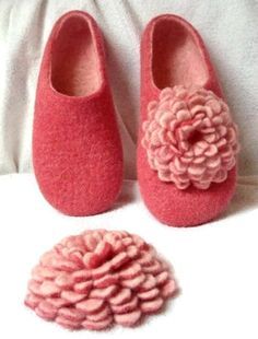 there is a pair of pink slippers with a flower on it