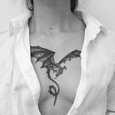 a woman with a dragon tattoo on her chest