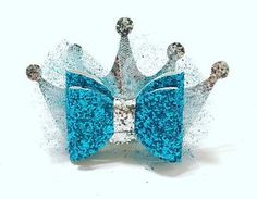 a blue and silver glittered crown on white background