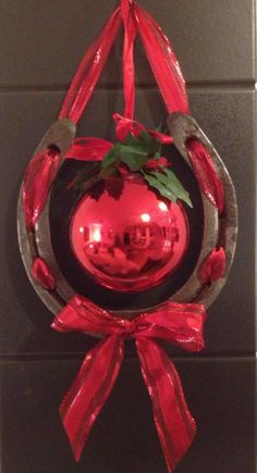 a red christmas ornament hanging from a wall