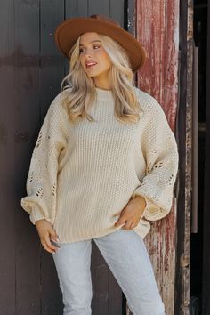 This Crochet Sleeve Pullover Sweater in Cream offers a chic blend of texture and style! Featuring long balloon sleeves with intricate crochet detailing, this sweater adds a unique flair to any outfit. It has a round neckline with ribbed detailing at the neckline, cuffs, and hem, enhancing its cozy feel. Designed with an oversized fit, it's perfect for layering and everyday comfort. Style with jeans, ankle booties, and a wide brim hat for an elevated chic outfit. Trendy Textured Knit Sweater With Balloon Sleeves, Trendy Textured Knit Balloon Sleeve Sweater, Trendy Balloon Sleeve Textured Knit Sweater, Oversized Pointelle Knit Chic Top, Trendy Chunky Knit Sweater With Balloon Sleeves, Winter Knit Sweater With Lantern Sleeves, Chic Oversized Pointelle Knit Top, Casual Textured Knit Sweater With Balloon Sleeves, Oversized Puff Sleeve Sweater For Fall