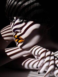 a woman with black and white stripes on her face