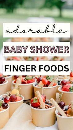 baby shower finger foods are displayed in small cups with strawberries and berries on them