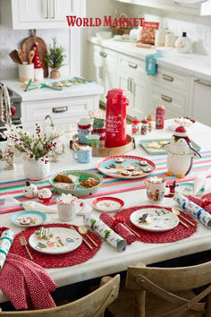 the table is set for christmas dinner with red and white placemats on it