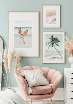 a pink chair sitting next to a white dresser and a bed in a room with pictures on the wall