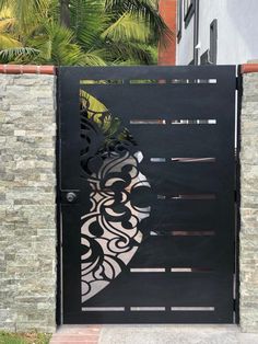 a black gate with an intricate design on it