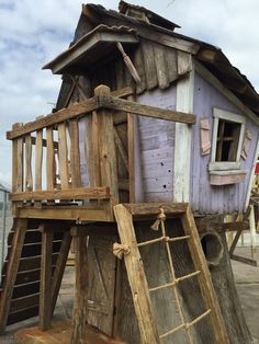 a house made out of wood and ladders