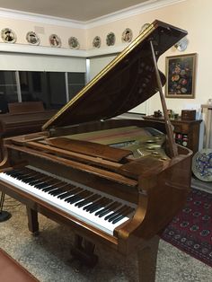 a grand piano sitting in the middle of a living room