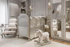 a baby's room with a rocking horse and crib in the corner, mirror on the wall