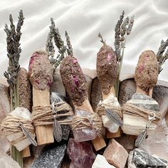 several different types of rocks and stones are arranged on top of each other, with flowers in the middle