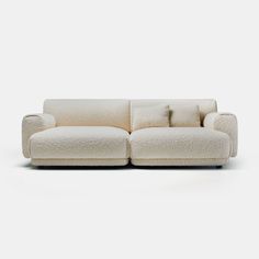 a white couch with pillows on it