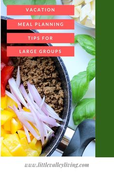 a bowl filled with meat and vegetables on top of a white table next to green leaves