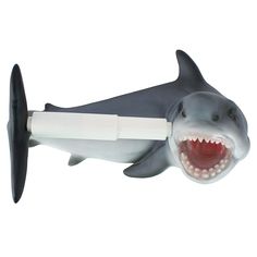 a toy shark with an electric toothbrush in its mouth