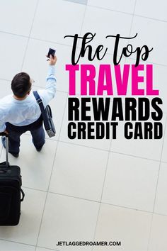 the top travel reward credit card is being held by a man in a suit and tie