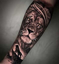 a man's arm with a lion and other animals on it, in black and grey