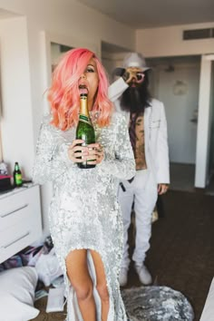 two people dressed in costumes and one is holding a bottle