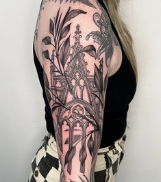 a woman with a black and white tattoo on her arm