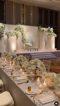 the tables are set with white flowers and candles for an elegant wedding reception at the four seasons hotel