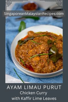 a white bowl filled with curry on top of a blue cloth