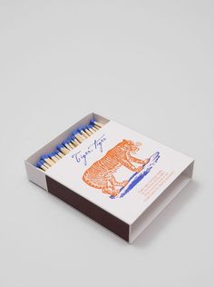 a matchbox with matches in it on a white surface