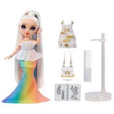 a doll with white hair and blue eyes wearing a rainbow dress, holding her hand up in the air