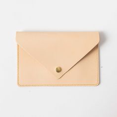 The leather clutch is handmade in the same beautiful full-grain leathers as our bestselling leather totes. It has a single interior compartment and is meticulously stitched on an industrial sewing machine. The leather clutch can be embossed with your initials at no additional charge. It measures 4.75 inches by 8.5 inches. Everyday Leather Envelope Pouch, Leather Envelope Clutch For Everyday Use, Classic Beige Leather Clutch, Leather Clutch With Card Slots, Soft Leather Envelope Clutch, Beige Leather Clutch With Card Slots, Beige Leather Clutch, Soft Leather Beige Clutch, Beige Soft Leather Clutch