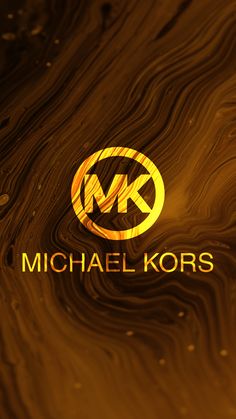 the michael kors logo is shown in gold and black on a wood grain background