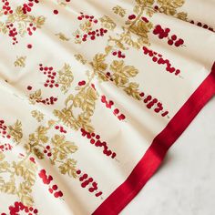 a white and red table cloth with gold leaf designs