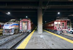 two trains parked next to each other in a train station