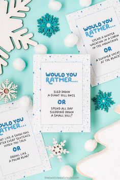 some snowflakes and cards that say i would you rather?