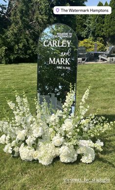 a memorial marker with flowers in the foreground