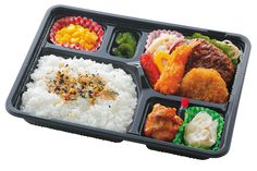 a tray with rice, meat and veggies in it on a white background