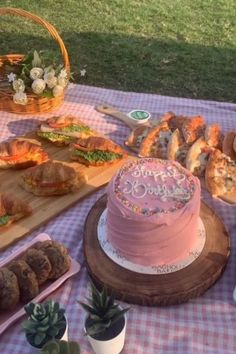 a table topped with lots of cakes and pastries on top of a checkered table cloth