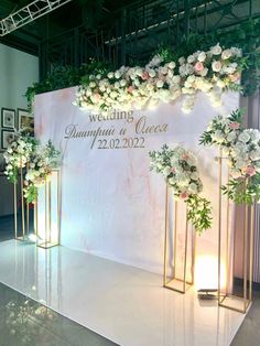 a wedding backdrop with flowers and greenery