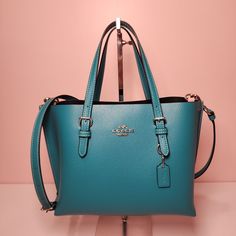 COACH  Mollie Tote 25 SV/Teal MSRP:  $378 Double face leather Zip-top closure, fabric lining Side open compartments Handles with 4 3/4" drop Detachable strap with 22" drop for shoulder or crossbody wear 9 3/4" (L) x 7 1/2" (H) x 4 3/4" (W) Style No. C4084 Coach Mollie Tote, Coach Mollie, Pebble Color, Black Crossbody Purse, Leather Duffle, Black Leather Purse, Coach Crossbody Bag, Crossbody Wallet, Black Leather Bags