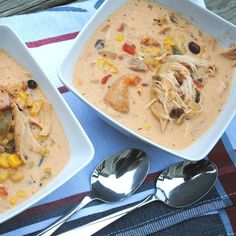 two white bowls filled with soup on top of a table