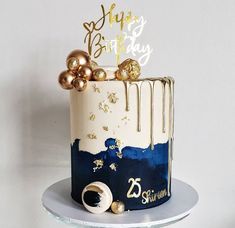 a white and blue cake with gold decorations