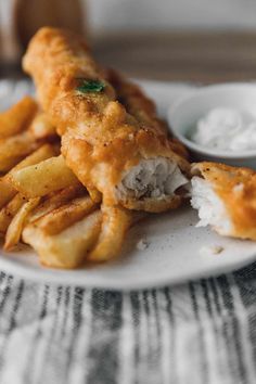 fried fish and fries on a white plate