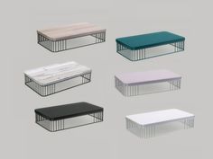 six tables with different colored tops and metal frames, all in various colors from white to blue